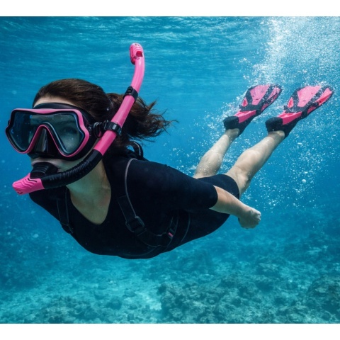 Kobieta nurkująca w zestawie do snorkelingu czarno różowym z płetwami