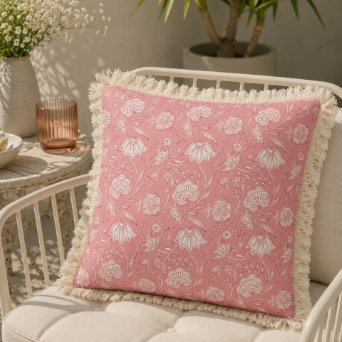 Różowa poszewka ogrodowa GAIA Pink Flower 45x45 cm z frędzlami na fotelu tarasowym w aranżacji boho